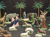 many figurines of people and animals on a table