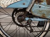 a close up of a motorcycle with a chain attached to it