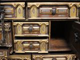 a wooden chest of drawers with many drawers on top of it