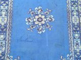 an oriental rug with a blue background and a floral design
