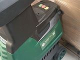 a green and black machine that is sitting on the floor