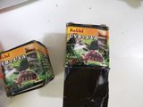 two packages of food sitting on a table next to a knife