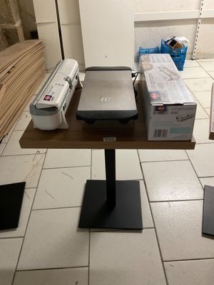 a small table with a printer and a printer on it