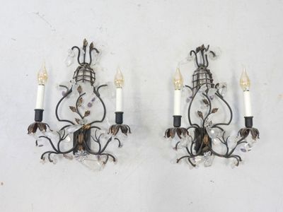 pair of wall sconces with crystals and leaves on each of them