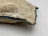 a small pillow that is on a white table