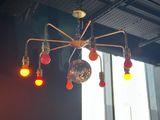 brightly colored lights hang from the ceiling of a dark room