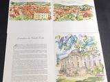 an open book with watercolor illustrations of buildings and trees