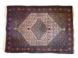 un tapis persan ancien orné d'un motif en losanges sur fond bleu