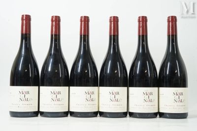 six bottles of wine are lined up in a row on a table