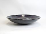 a black bowl that is sitting on a white surface
