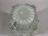 a glass object that is sitting on a white surface