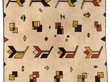un vieux tapis navajo orné de motifs géométriques sur fond blanc