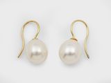 a pair of pearl earrings on a white background