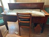 a desk with a chair and a table with a marble top