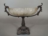 a glass bowl that is sitting on a stand