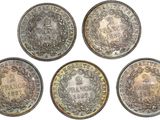 four different types of coins are shown on a white surface