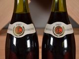 two bottles of wine that are sitting on a table