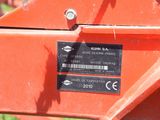 a close up of a red tractor with a label on it