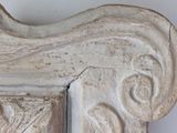 a close up of a carved frame on a wall