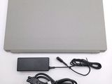 a laptop with a power cord and a charger on the table