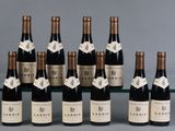 six bottles of wine are lined up in a row on a table