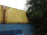 a yellow and blue container sitting on top of a building