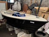 a black and white boat sitting in a warehouse