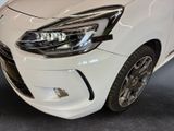 a close up of a white car in a showroom