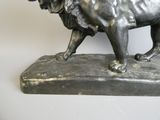 a statue of a lion that is standing on a base