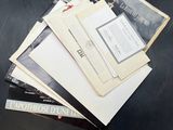 a pile of papers sitting on top of a black table