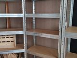 many shelves with boxes on them in a room