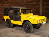 a yellow jeep parked in a garage with a brick wall