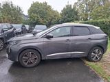 a grey suv parked in a parking lot next to other cars