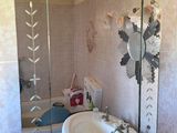 a bathroom with a sink and a mirror on the wall