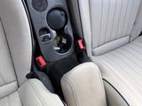beige leather seats in a white sports car with a black center console