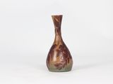 a small vase that is sitting on a white surface