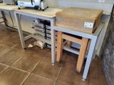 a table with a cutting board on it and a toaster on the table