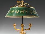 a green and gold table lamp with a bird on it