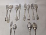 a lot of spoons and forks laid out on the table