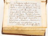 an old book with writing on it sitting on top of a table