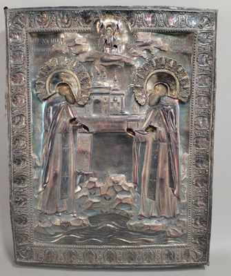 une image représentant une plaque métallique sur laquelle figurent deux personnes assises à une table