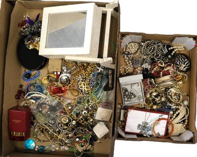 a box full of assorted jewelry on a white surface