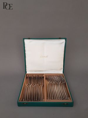 un service d'argenterie dans un coffret vert doublé de blanc