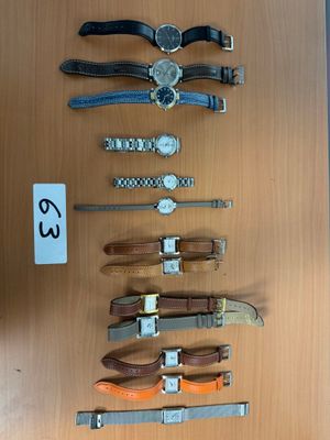 many different types of watches on display on a table