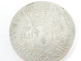 a silver coin with a picture of a man on it