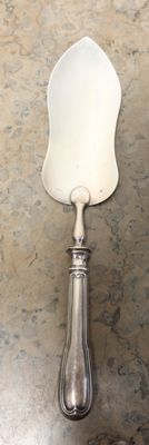 a silver spoon with a white handle on a marble table