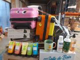 several pieces of luggage sitting on top of a cart in a warehouse