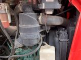 a red truck that has a bunch of wires attached to it