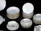 many different types of plates and bowls on the table