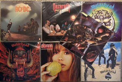 several albums of heavy rock music are on display on a table